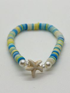 Handmade 7 in. preppy beaded bracelet. Contains blue, yellow, and clear clay beads. Also has pearl beads, and a cute starfish bead!! This is an adorable summer bracelet, and it would be the perfect gift for anyone and even for yourself! Handmade clay bead bracelet.  I can custom create any jewelry for you. Just let me know what colors you want, and if you want a word on it or not. I can also make phone charms and rings, and necklaces. Playful Blue Jewelry For The Beach, Cute Heishi Bead Bracelets For Beach, Playful Blue Jewelry For Vacation, Playful Yellow Beach Jewelry, Clay Beads Ideas Summer, Clear Clay, Anklets To Make, Bracelets Preppy, Make Clay Beads