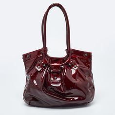 SALVATORE FERRAGAMO Maroon Patent Leather Gancini HoboThis bag from Salvatore Ferragamo will be your favorite accessory in no time. It is made from maroon patent leather on the exterior. It comes with top handles and a spacious fabric lined interior. This bag will help you flaunt a classy style Size: Height: 27 cm, Width: 8 cm, Length: 35 cmMaterial: Leather Maroon Bag, Bag For Wedding, Beaded Handbag, Classy Style, Balenciaga Designer, Dior Shoes, Red Satin, Designer Bag, Chanel Handbags