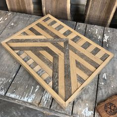 a wooden box sitting on top of a wooden table next to some wood planks