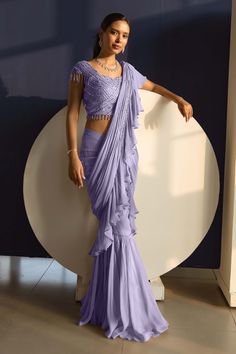 Lavender pre-draped gharara saree with ruffle detailing. Comes with linear embroidered blouse.
Components: 2
Pattern: Embroidery
Type Of Work: Linear
Neckline: Sweetheart
Sleeve Type: Sleeveless
Fabric: Georgette
Color: Purple
Other Details: 
Beaded tassel detailing
Occasion: Destination Wedding - Aza Fashions Gharara Saree, Indian Evening Gown, Drape Sarees, Indian Bridesmaid Dresses, Fashionable Saree Blouse Designs, Ruffle Saree, Saree Gown, Saree Designs Party Wear, Readymade Saree