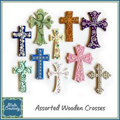 assorted wooden crosses are displayed on a white background