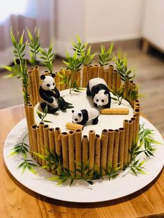 a cake decorated with bamboo sticks and panda bears