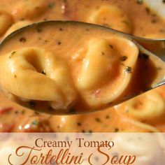 a spoon full of creamy tomato soup with dumplings in it and the title overlay reads, creamy tomato soup