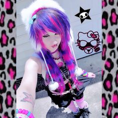 a girl with pink and purple hair is posing for the camera