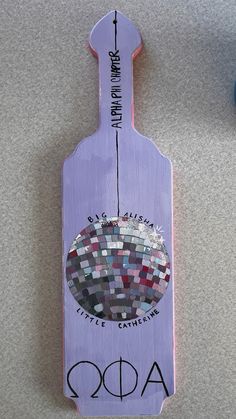 a purple bottle shaped like a mosaic tile