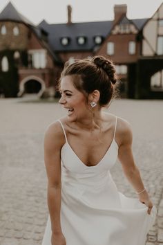 a woman in a white dress is smiling