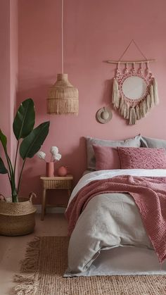 a bedroom with pink walls and white bedding in the corner, two planters on either side of the bed