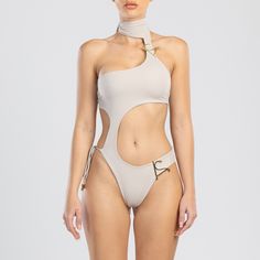 Designed with an asymmetrical shape and embellished with our AS logos, this asymmetric one piece swimwear is inspired by our signature Dulcet two piece swimwear. A stylish swimsuit featuring adjustable fastenings around the chest, neck, and bottom of the garment. With its double layered design, this piece is made of a recycled Italian fabric that ensures maximum comfort and a greater level of coverage.  Unleash a fashion-forward edge by pairing our Clementine Cover-up, Nety Pants In Black or wit Futuristic Swimwear, Luxury Beachwear, Beachwear Collection, Cut Out One Piece, Swimsuit Design, Two Piece Swimwear, Compression Fabric, Layered Design, Recycled Yarn