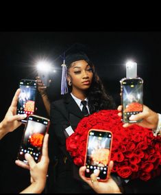 three women holding up their cell phones in front of them with roses and graduation caps on