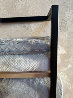 a wooden shelf with two pillows on top of it