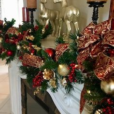 a christmas garland on a fireplace mantel with candles in the corner and decorations around it