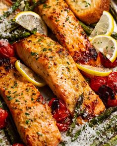 salmon and asparagus on a plate with lemons