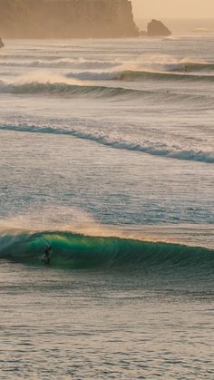 a person riding a wave on top of a surfboard