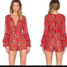 For Love And Lemons Beautiful Red Floral Long Sleeved Pia Romper. Front Lace Up Tie Closure. Deep V-Neck Hidden Back Zipper Fully Lined Side Seam Pockets Bell Sleeves Approx Measurements Length: 28.5" Armpit Across To Armpit: 17.25" Waist Across: 13.5" Care/Import Dry Clean Import Contents: Self: 100% Polyester Lining: 97% Polyester Nwot Size: Small Retail: $200.00 Red Printed V-neck Jumpsuits And Rompers, Red Long Sleeve Jumpsuits And Rompers For Summer, Red Long Sleeve Jumpsuits For Summer, Red Long Sleeve Jumpsuits And Rompers For Date Night, Red Printed V-neck Jumpsuit Or Romper, Red Printed V-neck Jumpsuit, Red Floral Print Jumpsuit With V-neck, Chic Red Floral Print Jumpsuit, Lemon Pants