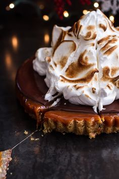 a chocolate dessert with whipped cream and caramel drizzled on the top