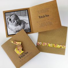 three folded cards with an image of a baby in the middle one has a bow on it