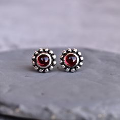 ✦ Introducing our natural red Garnet studs! These beautiful earrings are made of solid sterling silver and feature stunning, one-of-a-kind stones with some bohemian vibes. They're perfect for a special treat to yourself or a unique gift for a girlfriend or for your loved ones. We only use the finest quality natural stones in our jewelry, so you can be sure these earrings will be a cherished part of your collection for years to come. Don't miss out on this must-have accessory! 💎 Please Note As w Red Sterling Silver Birthstone Earrings, Red Birthstone Sterling Silver Earrings, Garnet Gemstone Earrings As A Gift, Silver Garnet Birthstone Earrings, Silver Ruby Earrings With Birthstone, Ring Size Adjuster, K Ring, Bohemian Vibes, Etsy Bridesmaid Gifts