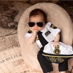 a baby doll wearing sunglasses is sitting in a chair