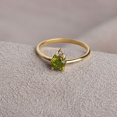 "With its shimmering pale green color, peridot stone is also known as the \"evening emerald\". It is a gemstone often associated with spirituality and expression. Peridot: This stone, called the \"Emerald of the Night\" in ancient Egypt, is believed to protect the person using it like a shield. Peridot is the birthstone for those born in August. Meet the essence of elegance: Solitaire peridot ring. Handcrafted with precision, this exquisite piece features a majestic sapphire set in a magnificent Elegant Peridot Birthstone Ring For Wedding, Formal Peridot Birthstone Ring For May, Green Diamond Ring In 14k Gold As Gift, Elegant Peridot Wedding Birthstone Ring, Elegant Peridot Birthstone Ring With Prong Setting, Diamond Ring For May Birthstone As A Gift, Wedding Jewelry With Brilliant Cut Peridot, Green 14k Gold Diamond Ring For Anniversary, Green Diamond 14k Gold Ring For Anniversary