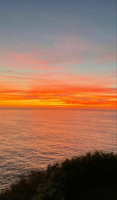 an orange and blue sunset over the ocean