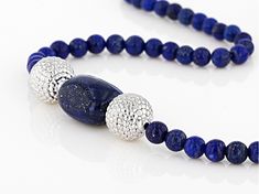 4mm-4.5mm round and approximately 15x12mm rectangular lapis lazuli  sterling silver bead necklace. Measures approximately .42"W. Lobster claw closure. Rhodium plated. Size and shape may vary. Silver Lapis Lazuli Jewelry With Polished Beads, Silver Lapis Lazuli Gemstone Beads Necklace, Elegant Lapis Lazuli Necklace With Polished Beads, Silver Lapis Lazuli Round Bead Jewelry, Silver Lapis Lazuli Necklace With Polished Beads, Silver Lapis Lazuli Necklace With Gemstone Beads, Lapis Lazuli Gemstone Beads Necklace In Silver, Elegant Adjustable Lapis Lazuli Beaded Necklace, Elegant Silver Beaded Lapis Lazuli Necklace