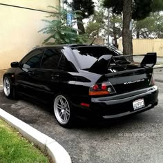 a black car parked in front of a building