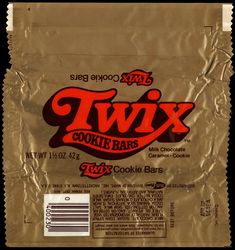 a close up of a bag of cookies on a black background with the word twix printed on it