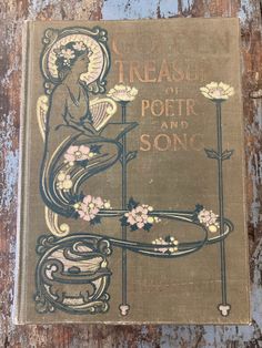 an old book is sitting on a wooden surface