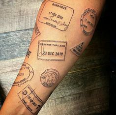 a man's arm with stamps on it and his name written in the middle