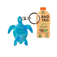 a bottle shaped keychain with a plastic sea turtle on it's side