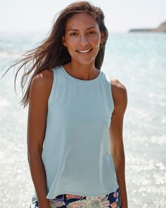 A ready-for-anything rashguard, to wear as a cover-up with a bikini top or as a tank with a sports bra. Crafted in a UPF 50+ swim fabric made mostly from recycled plastic bottles, with a breezy scalloped split back that can be tied for a more fitted silhouette.  By Carve Designs. Crew neckline. Sleeveless. UPF 50+ sun protection. Blue Top For Summer Water Sports, Upf 50+ Beachwear Tops For Swimming, Beachwear Tops For Water Sports Upf 50+, Beachwear Tops With Upf 50+ For Water Sports, Stretch Top For Water Sports In Summer, Beach Tops With Built-in Bra And Stretch, Upf 50+ Beachwear Tops For Water Sports, Versatile Moisture-wicking Summer Tops, Summer Tops For Water Sports With Uv Protection