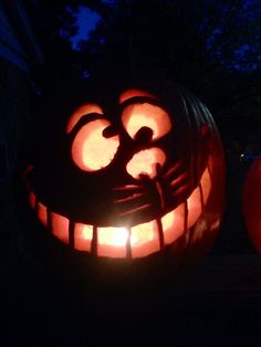 two pumpkins with faces carved into them