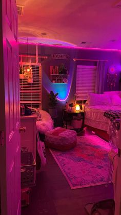 a bedroom with pink lights and rugs on the floor