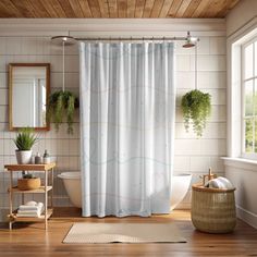 a bath room with a tub and a shower curtain in it's center area