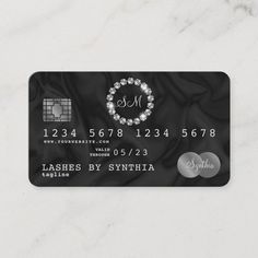 a black and white business card with diamonds on the front, and an embellishment in