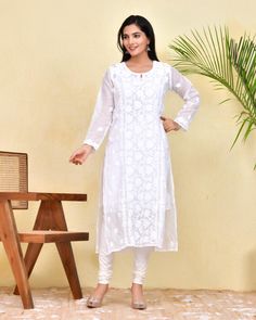 Our White Chikankari Kotadoria Straight Kurta is crafted from high-quality cotton for superior comfort and fit. It features a relaxed fit that's perfect for everyday wear. Experience the utmost comfort without compromising an elegant style! Features: Long kurta in Pure soft Kotadoria cotton fabric Hand-embroidered with Chikankari  work Our model is wearing size S and is 5 feet 6 inches tall. Length: Kurta - 47" inches |  Fabric: Pure Soft Cotton Embroidery : Chikankari ghasspatti work Color: White Print : Floral Print Matching White Pant or sharara is avl Inner or white Cotton Slip is avl. Pls message if you required. Garment-Care We recommend to dry clean only. Do not soak and scrub the product and dry it in shade. Do not iron on embellishments. Unstitched Long Sleeve Cutwork Kurta, Long Sleeve Kurta With Cutwork For Eid, Anarkali Long Sleeve Kurta With Cutwork, Anarkali Kurta With Long Sleeves And Cutwork, Anarkali Kurta With Cutwork And Long Sleeves, Semi-stitched Long Sleeve Chikankari Kurta, Traditional White Chikankari Long-sleeve Wear, Traditional Long Sleeve Kurta With Cutwork, White Traditional Wear With Chikankari Embroidery And Long Sleeves