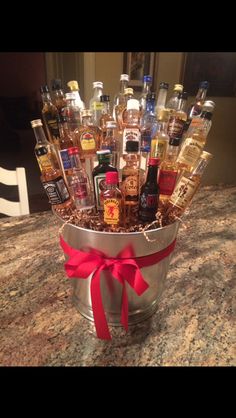 a bucket filled with liquor bottles on top of a counter