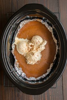 there is a pie in the crock pot with ice cream and cinnamon on top