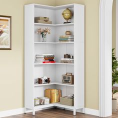 a white book shelf with books and other items on it in a living room area