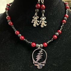 Grateful Dead Stealie Beaded 17” Necklace With Lobster Clasp And Matching Dancing Bear Lightweight Hanging Earrings Themed Black Jewelry As Gift, Themed Black Jewelry Gift, Handmade Themed Pendant Jewelry, Nickel-free Red Themed Jewelry, Nickel-free Themed Red Jewelry, Handmade Themed Jewelry Gift, Handmade Themed Jewelry For Gift, Themed Red Nickel-free Jewelry, Themed Handmade Jewelry Gift