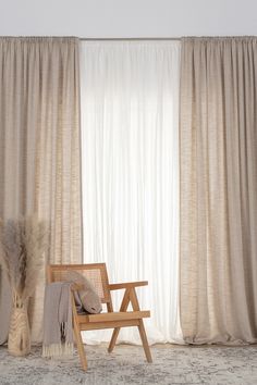 a wooden chair sitting in front of a window