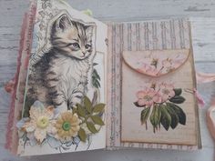 an open book with a kitten and flowers on it