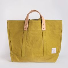 Constructed from custom-dyed 18oz cotton canvas and copper hardware, the East-West Tote converts from handheld to shoulder bag via detachable leather handles. Once the handles are removed, the tote is washable (see care instructions below). The Small size is a perfect day bag, and can easily carry your laptop, a sweater and lunch. Sturdy 100% Cotton CanvasLeather Handles (Detachable)Cotton Webbing HandlesCopper Collar Buttons and Rivets 13”H x 5”D x 18”WLeather Handle Drop: 4"Webbing Handle Drop Cork Bags, Copper Hardware, Overnight Travel Bag, Cork Bag, Bucket Tote, Multipurpose Bag, Bag Ideas, A Perfect Day, Crafty Projects