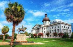 the state capitol building in charleston, sc with palm trees and a statue of a man on a horse