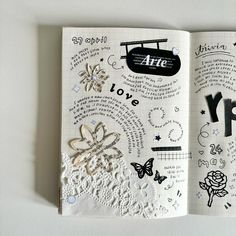 an open notebook with drawings and words on it