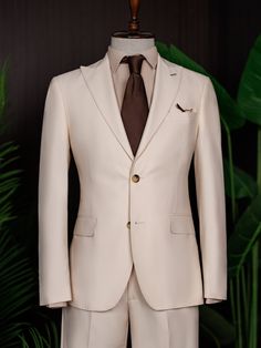 Color: beige Material: 73% polyester, 23% viscose, 4% elastane Suit includes blazer, waistcoat, & trousers Single-breasted suit (2-button blazer) Lapel type: peak lapels Jacket interior lining option: fully-lined Jacket vent: double vent Fitting: modern-fit Care instructions: dry clean only Machine washable: no Luxury Beige Blazer For Semi-formal Events, Beige Single Breasted Suit Set For Work, Cream Single Breasted Blazer With Suit Collar, Cream Single Breasted Blazer With Notch Lapel, Luxury Beige Blazer With Suit Collar, Cream Single-breasted Blazer With Suit Collar, Luxury Beige Single-breasted Suit, Tailored Beige Office Sets, Beige Double Breasted Suit For Business Casual