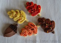 four decorated cookies sitting on top of a table