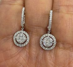 Beautiful Diamond Drop Earrings set with white and sparkling diamonds.  Just dangle below the lob, not too long.  Classy and pretty earring.  The hoop earring fits nice around the lobe.  These earrings you can easily dress up or down in them.  Excellent craftsmanship, all diamonds set smooth.  The cluster of round diamonds in the center measures 6mm.  The halo measures 9.8mm.  The length measures about 24mm.  The hoops snaps tightly for a secure fit. Genuine earth mined round brilliant cut diamonds total weight: 0.95 carats Clarity: I Color: G All white and shiny diamonds, no cloudy or yellowish stones  18K White Gold Earring 3.83 grams  Comes with gift box * We have been in the wholesale Jewelry business for over 30 years serving the community at the same location.  All diamonds we use ar Diamond Drop Earrings Classy, White Diamond Drop Earrings With Vvs Clarity, White Brilliant Cut Dangle Diamond Earrings, Gia Certified Diamond Drop Earrings, Gia Certified White Gold Drop Diamond Earrings, Dazzling White Diamond Dangle Earrings, Gia Certified Dangle Diamond Earrings In White Gold, Gia Certified Dangle White Gold Diamond Earrings, Gia Certified White Gold Dangle Diamond Earrings