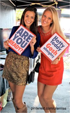 two women holding up signs that say, are you ready? and how do you think?