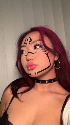 a woman with her face painted like a cat